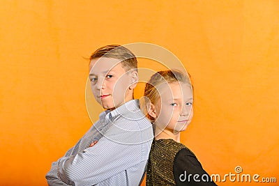 The boy plays the clarinet in the girlâ€™s ear, the outraged girl waves her arms Stock Photo